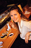 Woman at sushi restaurant