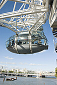 UK, London. Pod of the London Eye ferris wheel high over London