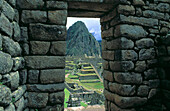 Ruins viewed through a doorway. Machu Picchu. Peru