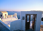 Greece, Cyclades Islands, Santorini, Oia village, White Churches front of the sea with door open to the sea.