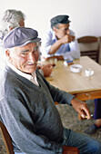 Greece, Cyclades Islands, Santorini. Men talking at café