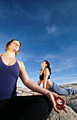 Women practicing yoga at Snow Canyon State Park. Utah, USA