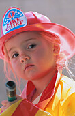 Young girl dressed in firefighter s clothes