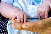 holding newborn hand