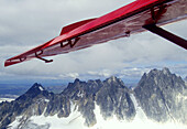 plane wing over Alaska range