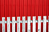 white fence with red wall