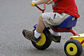 Toddler on toy tricycle