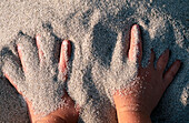 Hands in sand