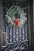 Snow dusted Christmas wreath hanging on a Brownstone door in New York City. USA