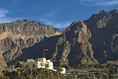 Omani flag flies from a government building, Wadi Bani Auf, Oman
