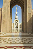 Archways and spire at the Sultan Qaboos Grand Mosque, Muscat, Oman