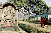  Adult, Adults, Asia, Asian, Asians, Color, Colour, Country, Countryside, Daytime, Ethnic, Ethnicity, Exterior, Female, Horizontal, Human, Monument, Monuments, Nepal, Outdoor, Outdoors, Outside, Pair, People, Person, Persons, Road, Roads, Sculpture, Symbo