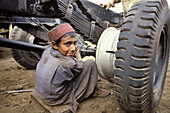 Garage mechanic. Young boy at work. Peshawar. NWFP (North-West Frontier Province (northwest Pakistan). Pakistan.