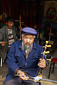 China. Yunnan province. Baisha village around Lijiang. Musician from Naxi ethnic group.