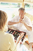 rs, 50-60 years, Adult, Adults, Amusement, Backgammon, Board game, Board games, Caucasian, Caucasians, Color, Colour, Companion, Companions, Contemporary, Couple, Couples, Daytime, Decision making, De