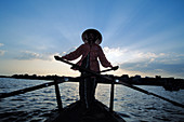 Rower in traditional river boat. Mekong Delta. Vietnam