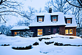 Suburban home at dusk immediately after snowstorm. Boston. Massachusetts. USA