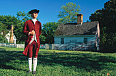 Interpreter at Duke of Glouster Street. Gentry gunsmith shop in background (c. 1770). Colonial Williamsburg. Virginia. USA