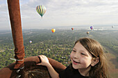 View from gondola, aerial, smiling girl, Tennessee River. Alabama Jubilee Hot Air Balloon Classic. Decatur, Alabama. USA.