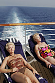  Adult, Adults, Baby boomer, Baby boomers, Basking, Bathing suit, Bathing suits, Calm, Calmness, Caucasian, Caucasians, Chill out, Chilling out, Closed eyes, Color, Colour, Contemporary, Cruise, Cruises, Daytime, Deck, Decks, Exterior, Facial expression, 