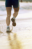 35 years old woman running on beach. California. USA.