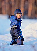 Little boy walking on snow. Västerbotten, Sweden
