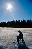 Ice fishing in direct light. Vasterbotten. Sweden