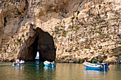 Boats on Dwejra Lake in front of a cave, Gozo, Malta, Europe