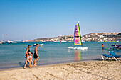 Family walking along the beach, Mellieha Bay, Malta, Europe