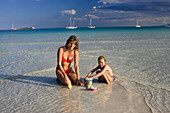 mother and daughter playing at Cala Brandinchi Beach, eastcoast, Sardinia, Italy