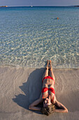 woman lying at Cala Brandinchi Beach, eastcoast, Sardinia, Italy