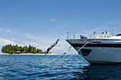 Man diving from a yacht, Luxury vacation on a private island with yacht, Rania Experience, Faafu Atoll, Maldives