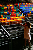 Girl and votive candles, Montserrat Monastery, Catalonia, Spain