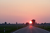Sunset over country road in the district of Telsiai, Lithuania