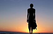 Woman on beach at sunset