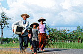 A family walking in the village of Prah Dah. Province of Siem Reap. Cambodia