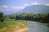 Nam Khan River and Wat Phone Phao in background. Luang Prabang. Laos