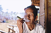 Old woman smoking a cheroot. Bagan. Myanmar (Burma)