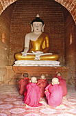 Novice monks praying buddha. Bagan. Myanmar (Burma)