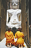 Novice monks Praying Buddha at temple Wat Si Chum. Sukhothai. Thailand