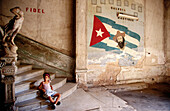 Interior of old palace with Cuban flag and portrait of Camillo Cienfuegos. Havana. Cuba