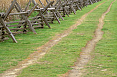 Oregon Trail ruts along wooden fence at Whitman Mission. Whitman Mission National Historic Site. Walla Walla. Washington. USA