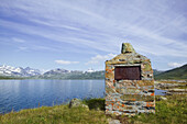 Monument over first tourist cabin built by Lake Tyin 1870, an important moment in the norwegian Mountaineering tradition. Jotunheimen, Oppland, Norway.