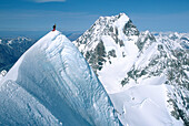 Climber on summit of Mt. Tasman. Mt. Cook behind. Fox Glacier. Westland National Park. New Zealand