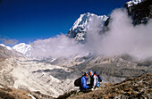 Trekkers. Wedge Peak above cloud. Lhonak. Kangchenjunga. East Nepal