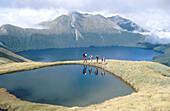 Walking group above Green Lake. Fiordland National Park. New Zealand.