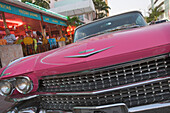 View at the radiator grill of a vintage car on Collins Avenue, Miami Beach, Florida, USA