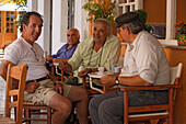 Greek men sitting in a cafe, Paxos, Ionian Islands, Greece