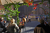 People sitting in front of a cafe in the sunlight, Via Cavour, Rome, Italy, Europe