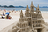 Building sand castles with nativity scene on Copacabana Beach, Copacabana, Rio de Janeiro, Brazil, South America